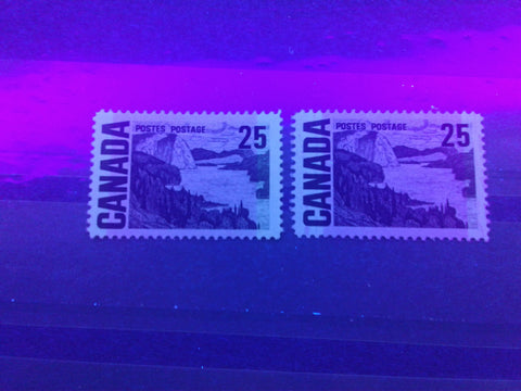 Light and dark Winnipeg tagging, as seen under UV light, on Canada #465, the 25c Solemn Land definitive from the 1967-1973 Centennial Issue