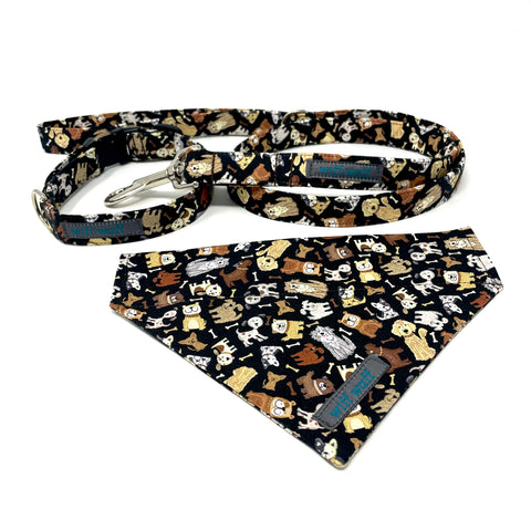 Image shows a handmade dog collar, lead and bandana made from high quality cotton fabric that is 100% washable. The fabric is printed with a cute dog print with various cartoon style breeds depicted coloured in shades of brown, yellow and white.