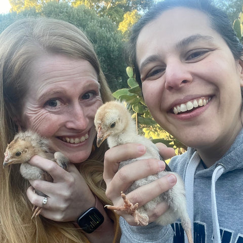 Jen and Leana hold chickens