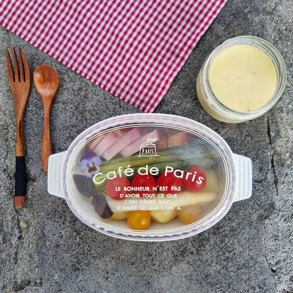 Homemade bento lunch of smoked ham, green & white asparagus, boiled potatoes, cherry tomatoes, Hollandaise sauce in a Café de Paris Dish Lunchbox with clear lid