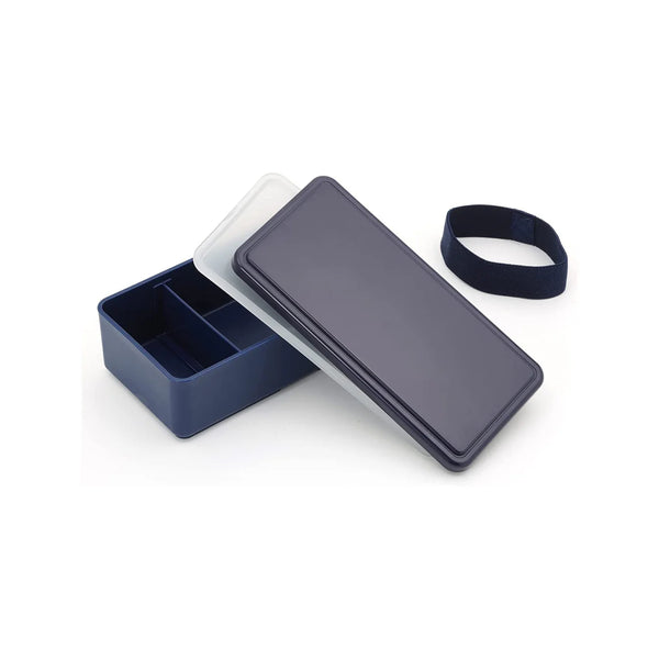 One-tier Navy bento box with an ice pack in the lid open on a white table,