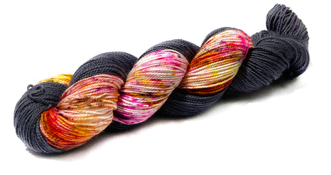 the woolly dragon hand dyed yarn black and speckle fireworks yarn