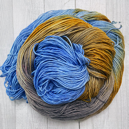 take it easy hand dyed yarn from the woolly dragon blue rust and brown