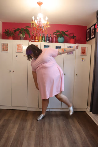 A fat babe in a plus size soft pink dress