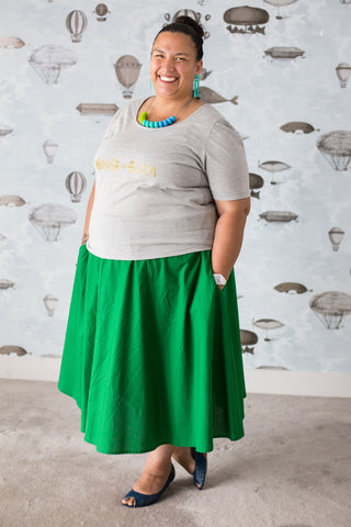 Tall Maori woman in bright green skirt