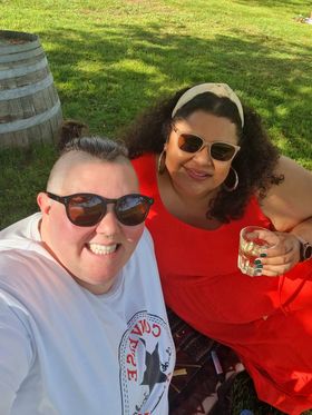 Fat babes Peta and Taina outside drinking wine and smiling in the sunshine