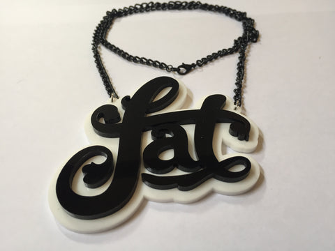 a laser-cut necklace that says fat