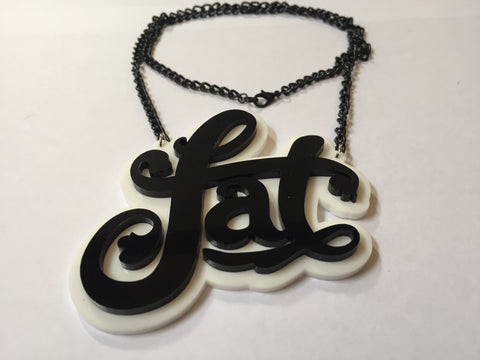 Necklace that says "fat" in fancy curly font