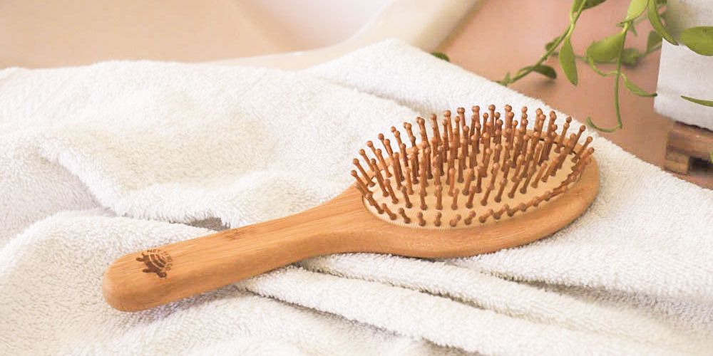 Bamboo hairbrush on bathroom counter