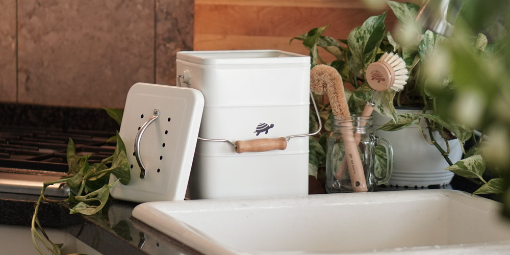 Net Zero Co.'s Kitchen Compost Bin on the counter