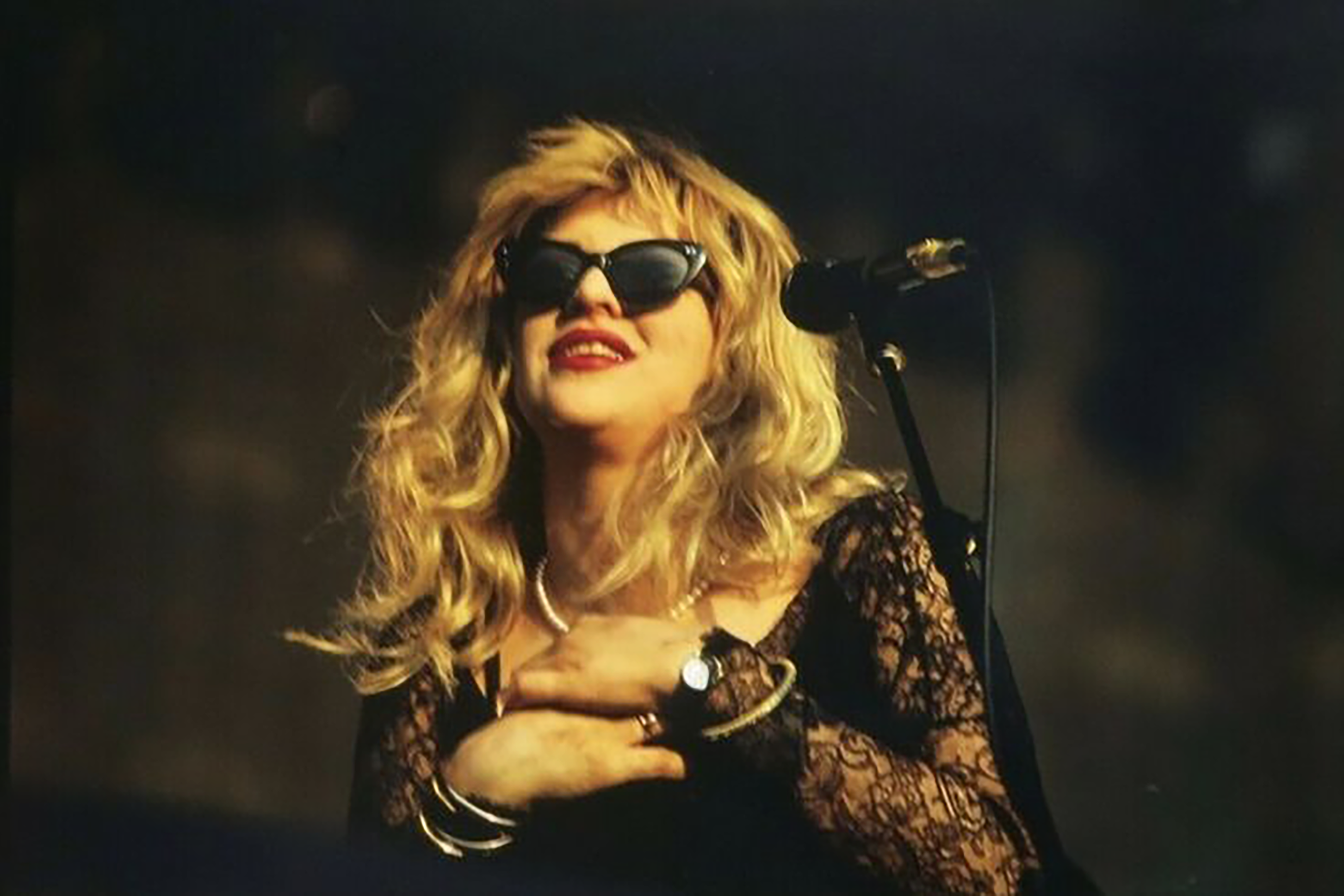 Courtney Love wearing black cat eye sunglasses