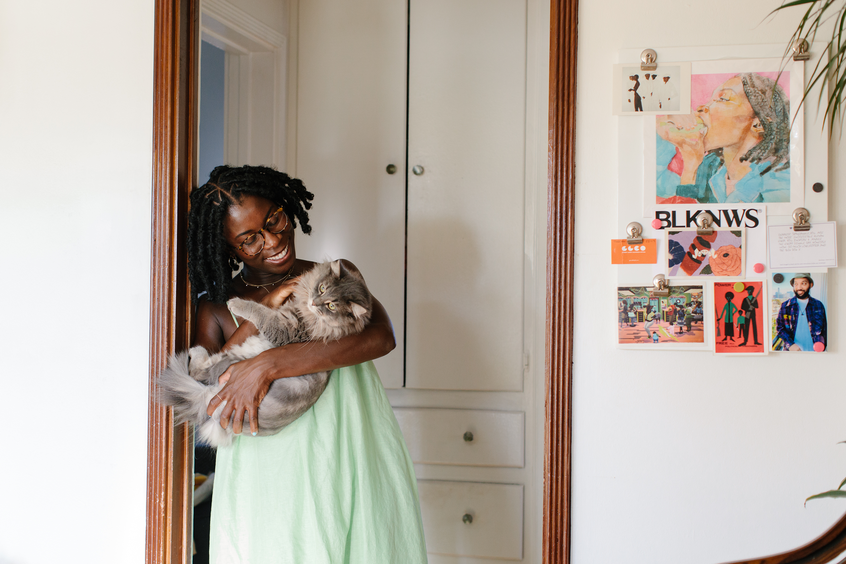 Dr. Yewande standing in the doorway holding her baby