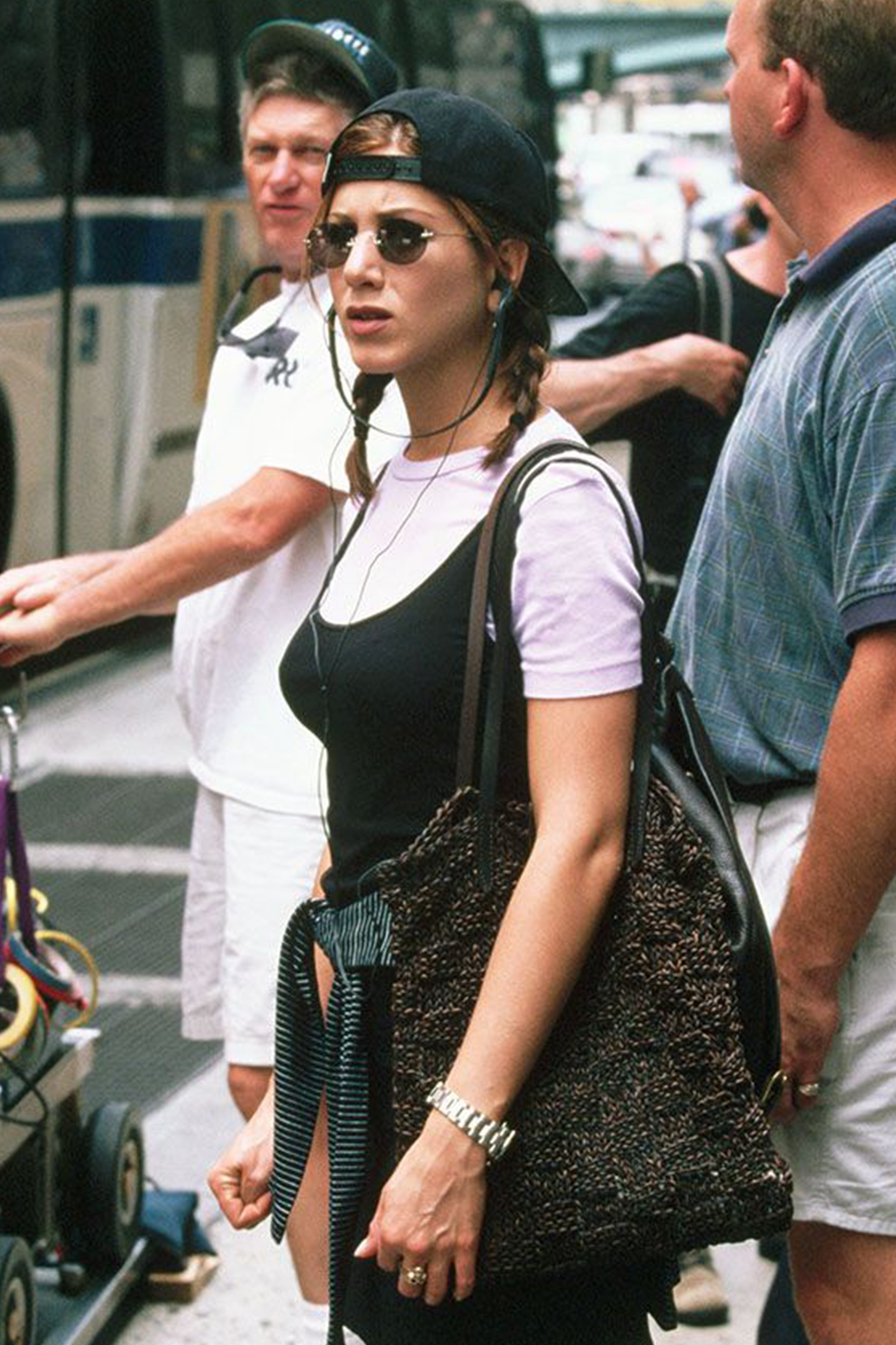 Jennifer Aniston sporting 90s street style in small, round sunglasses