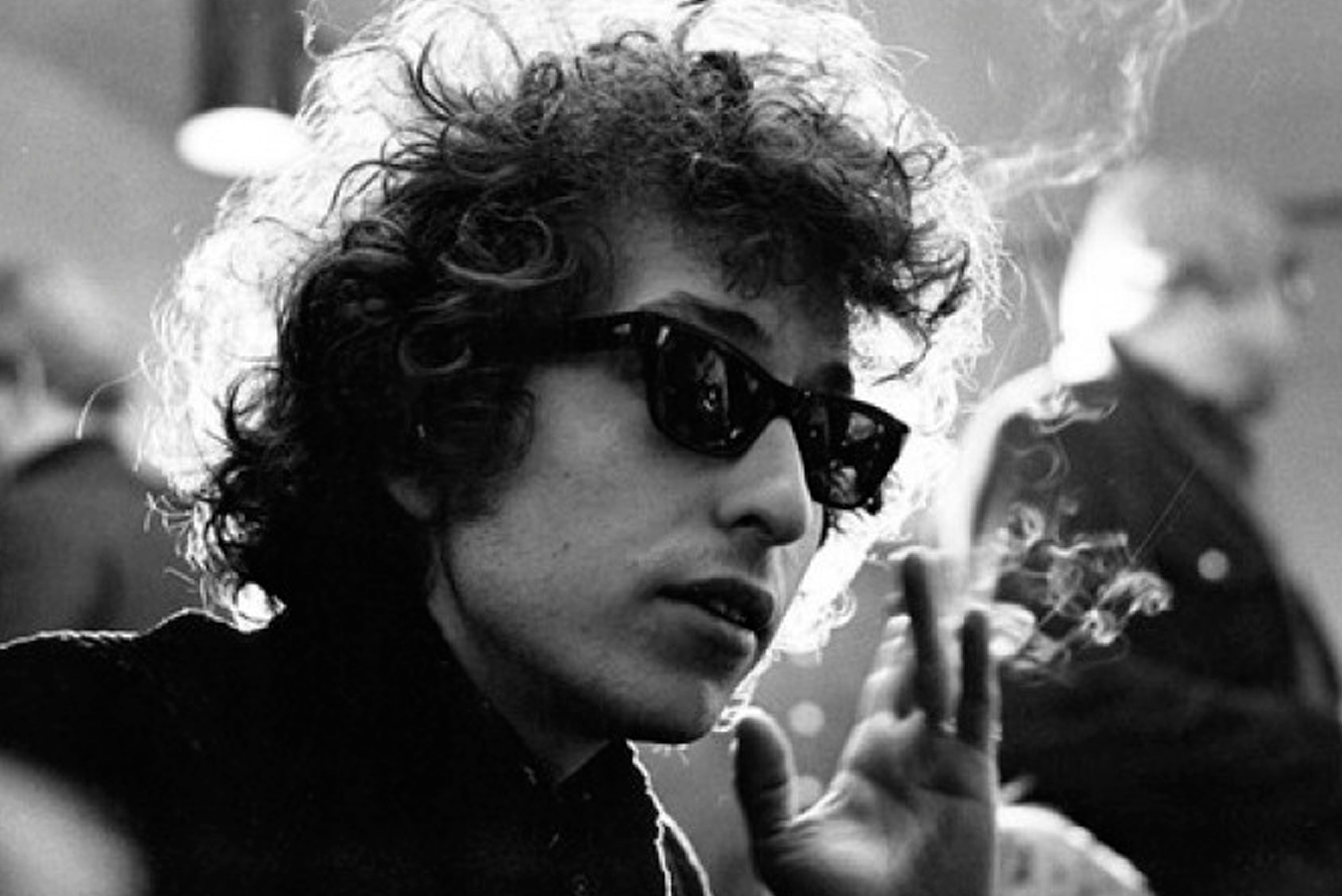 black and white photo of Bob Dylan wearing sunglasses