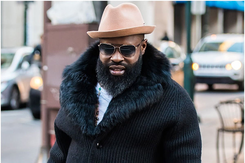 Black Thought in a fedora and fur coat