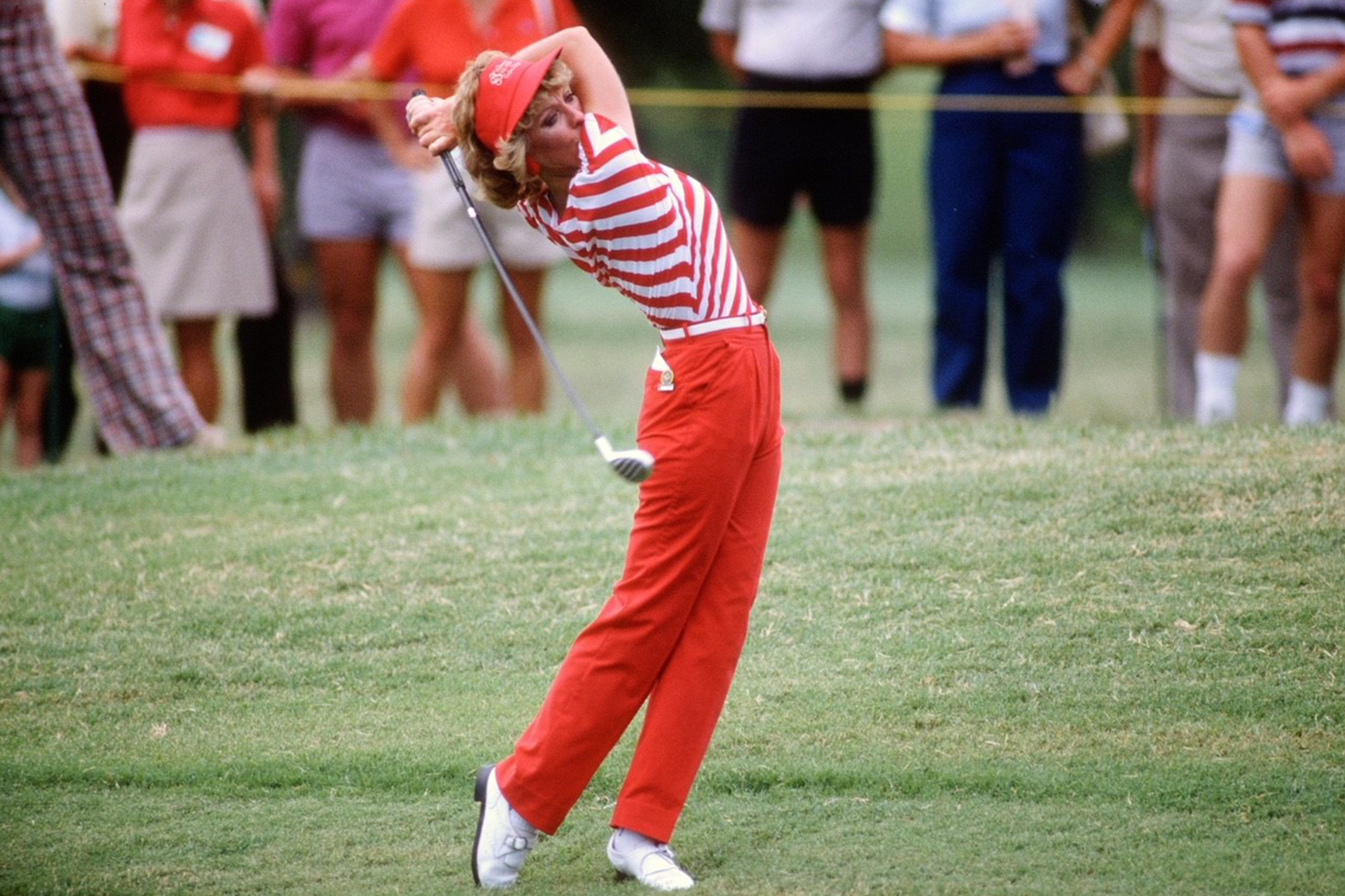 Jan Stephenson wearing red pants with a tucked in red and white striped shirt