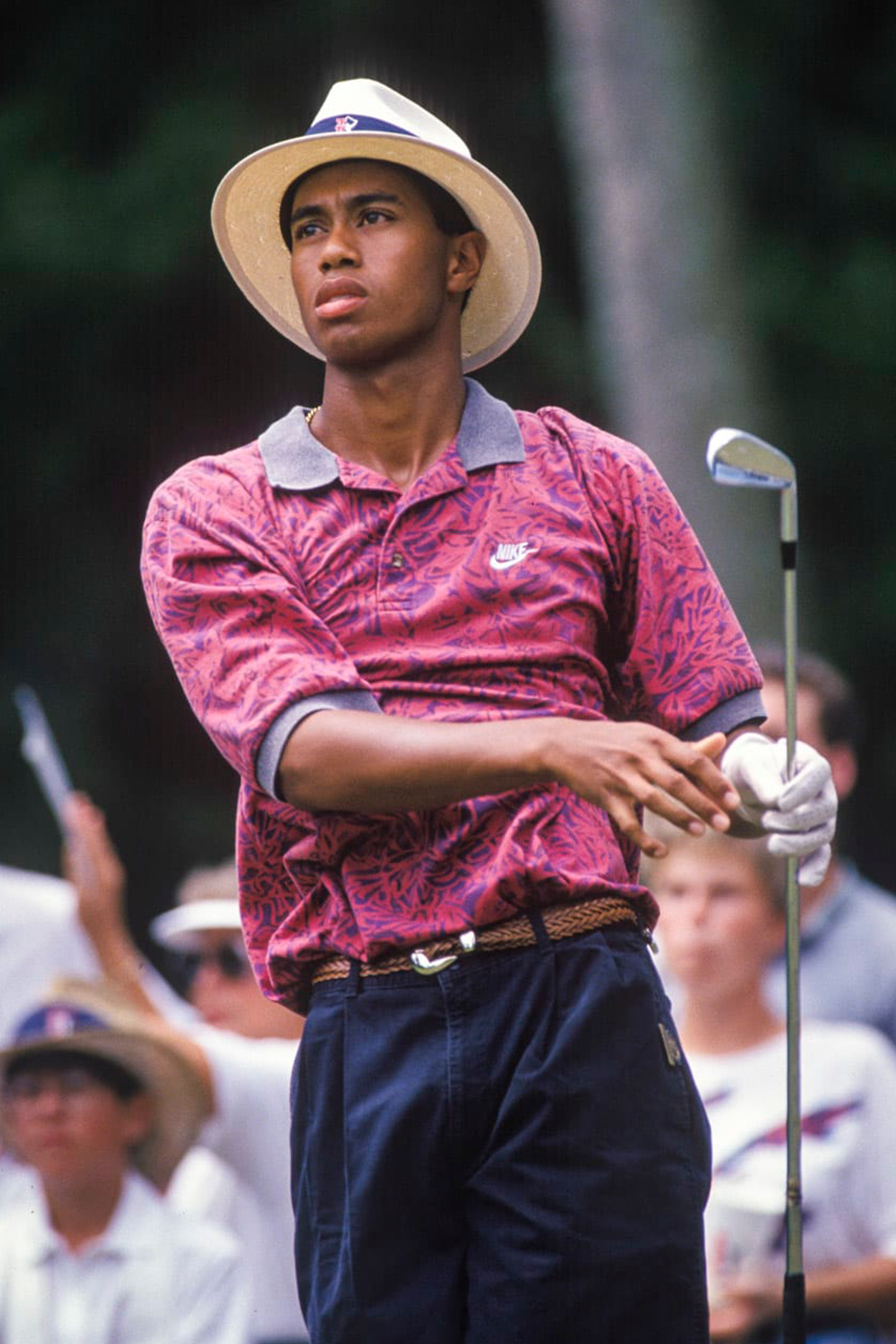 Tiger Woods wearing a fedora and a hot pink Hawaiian print Nike polo