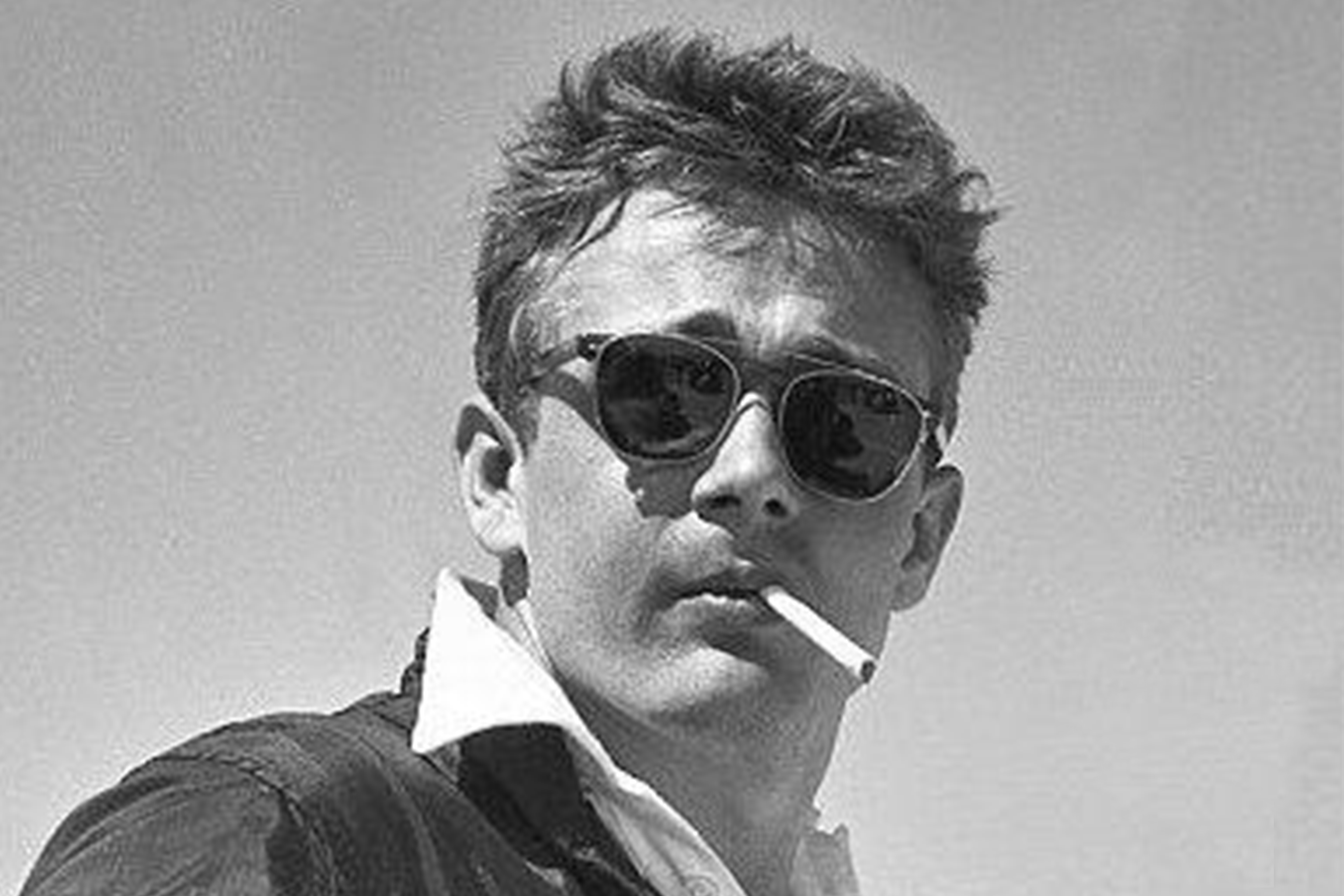 James Dean wearing P3 sunglasses and smoking a cigarette