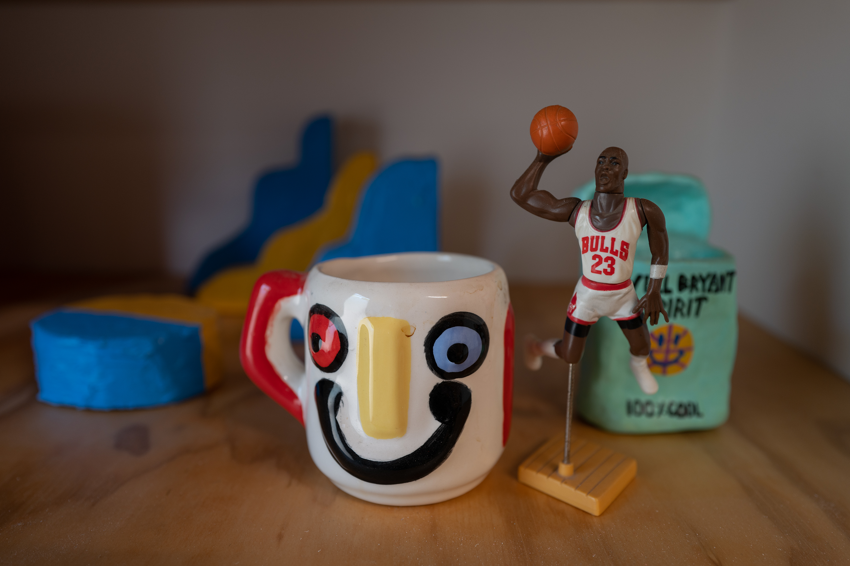 A painted smiley face mug sitting on a table