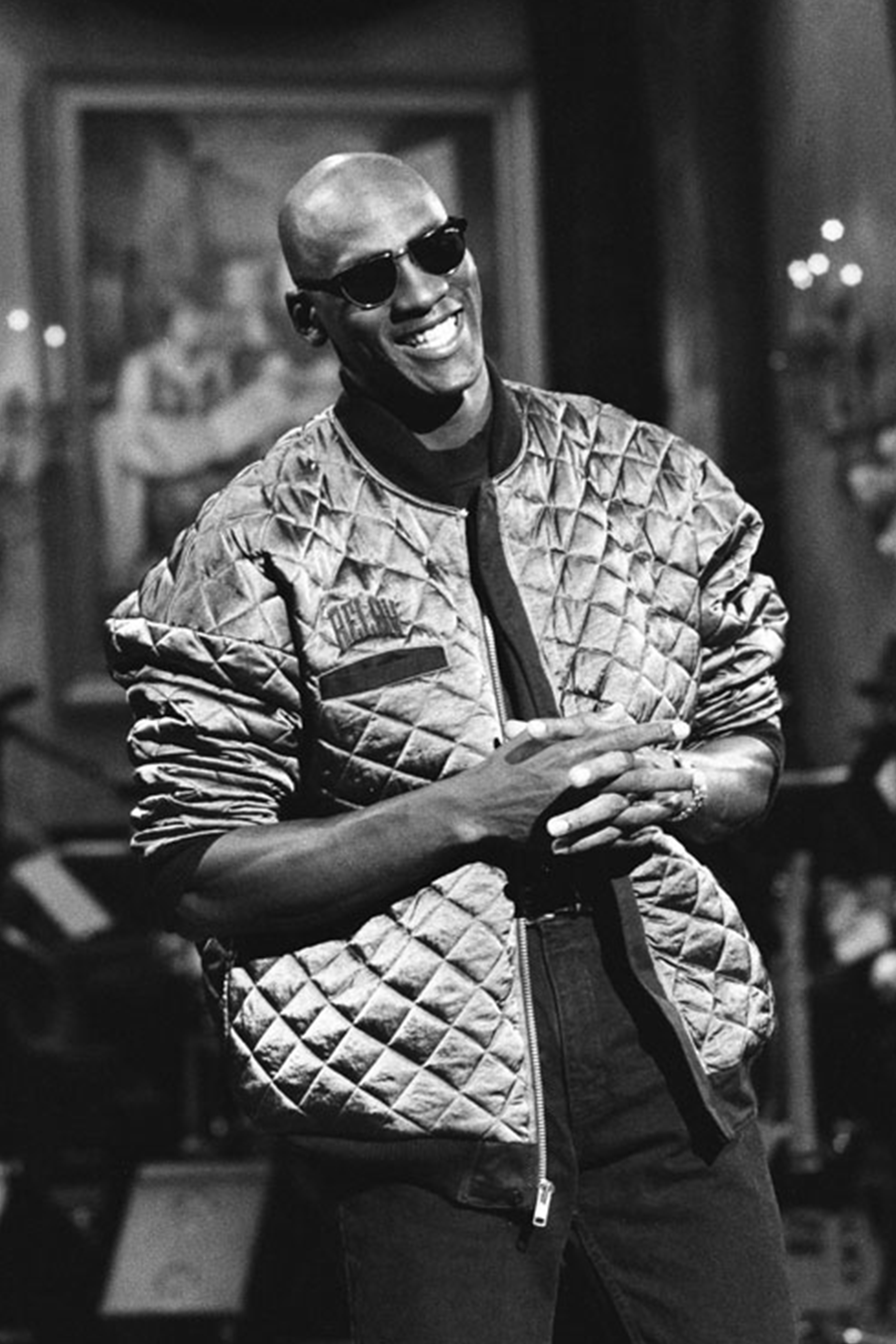 Michael Jordan wearing black Wayfarer-style sunglasses and a bomber jacket