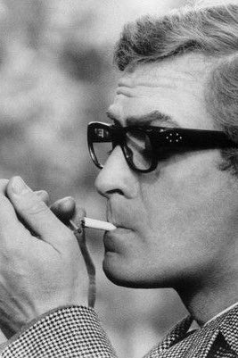 Black and white photo of Michael Caine wearing glasses