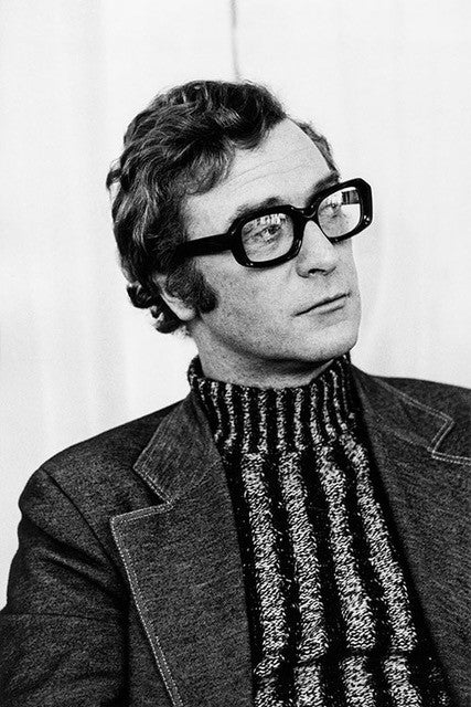 Black and white photo of Michael Caine wearing glasses