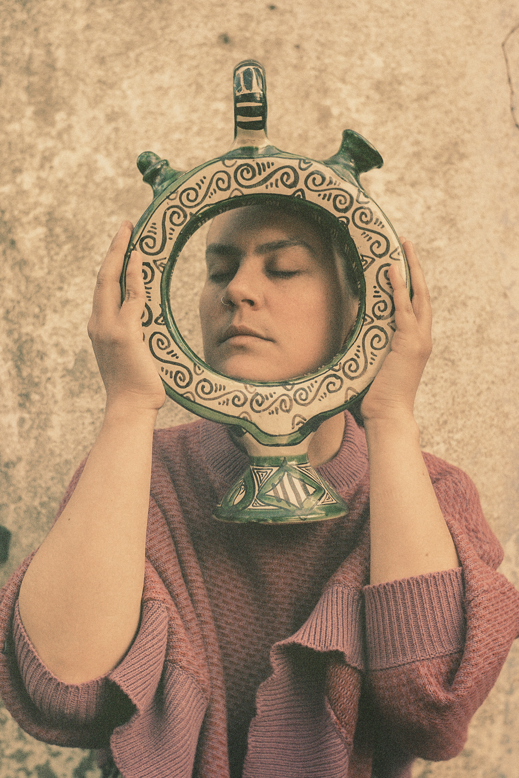 A woman holding a handmade vase