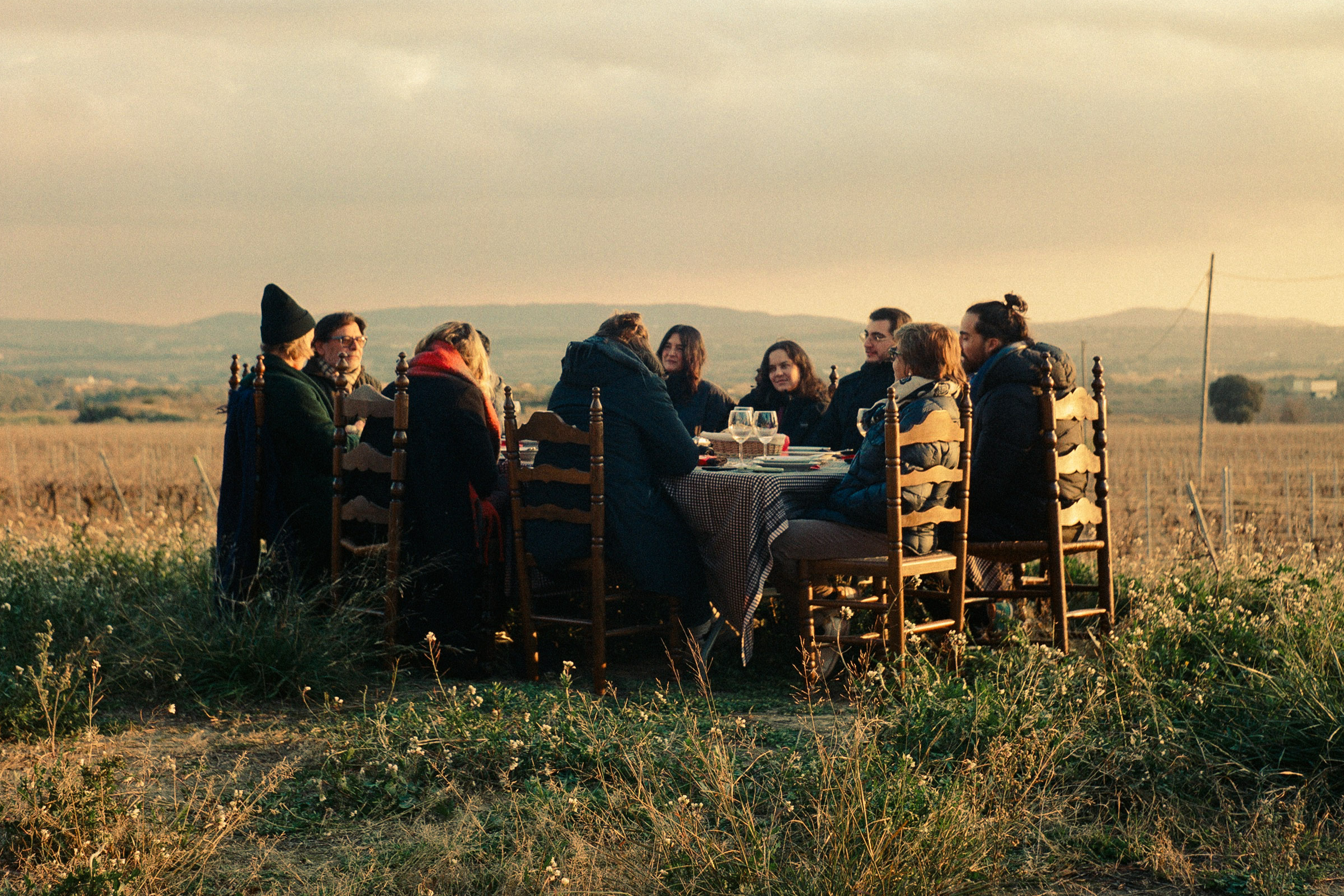 People gathered at the wood dining table for a meal