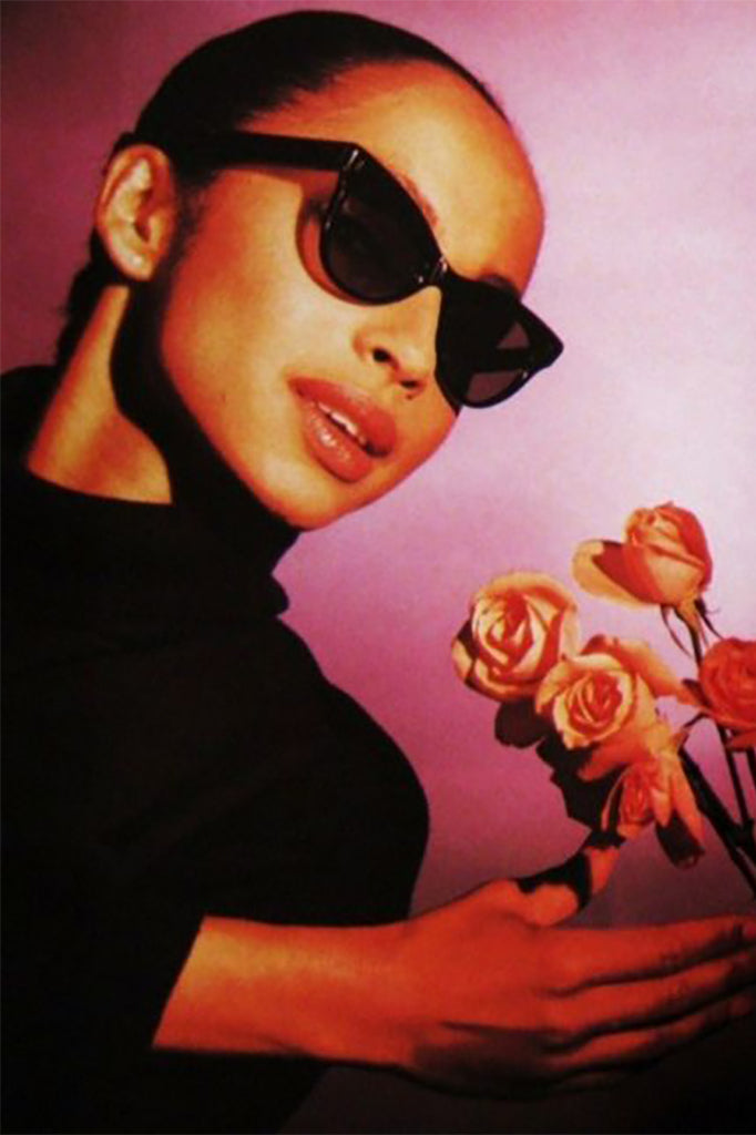 Sade wearing her signature cat eye sunglasses