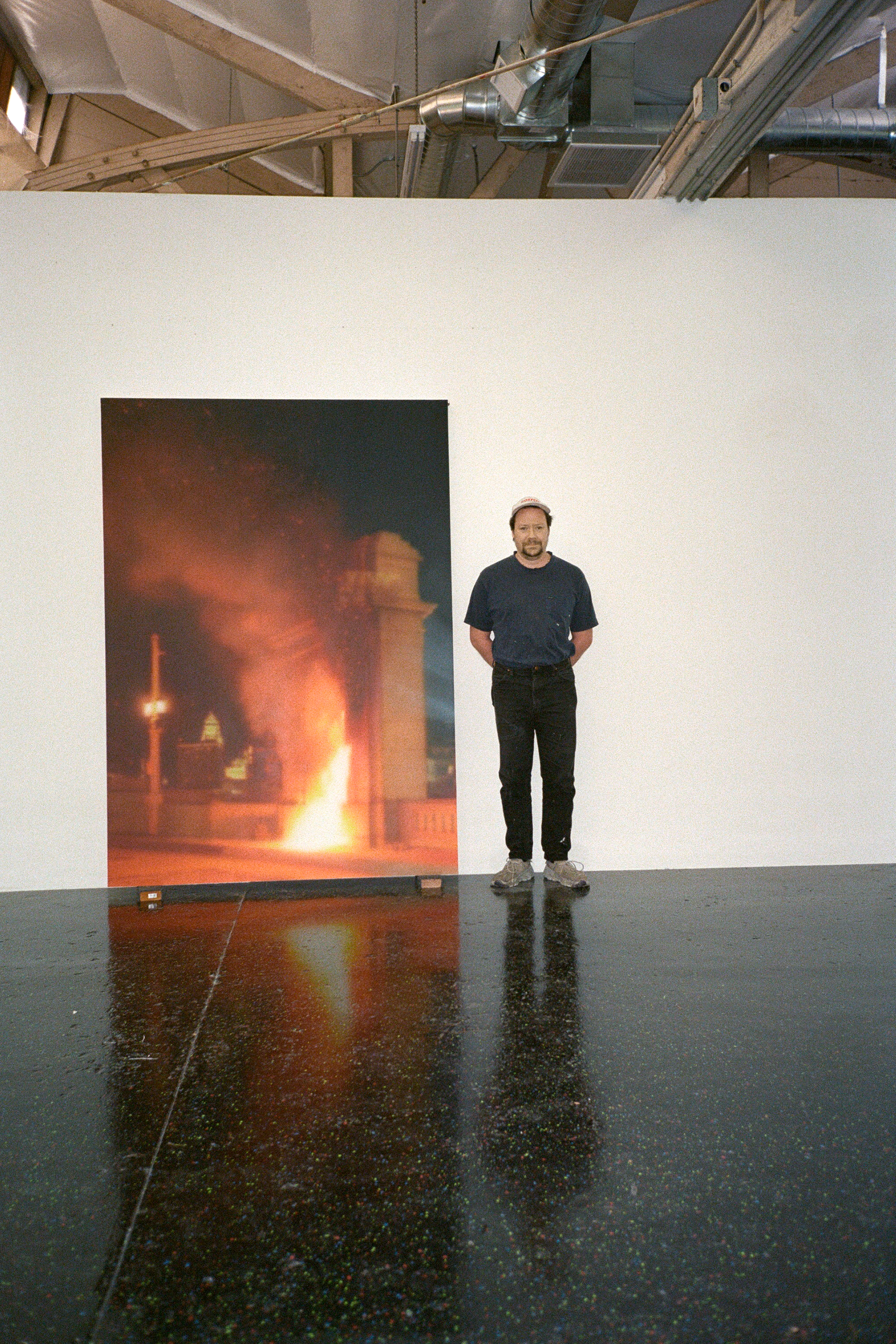 Sayre Gomez in front of one of his paintings