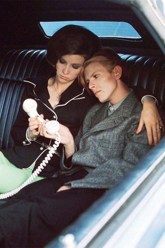 David Bowie sitting in a car with a woman