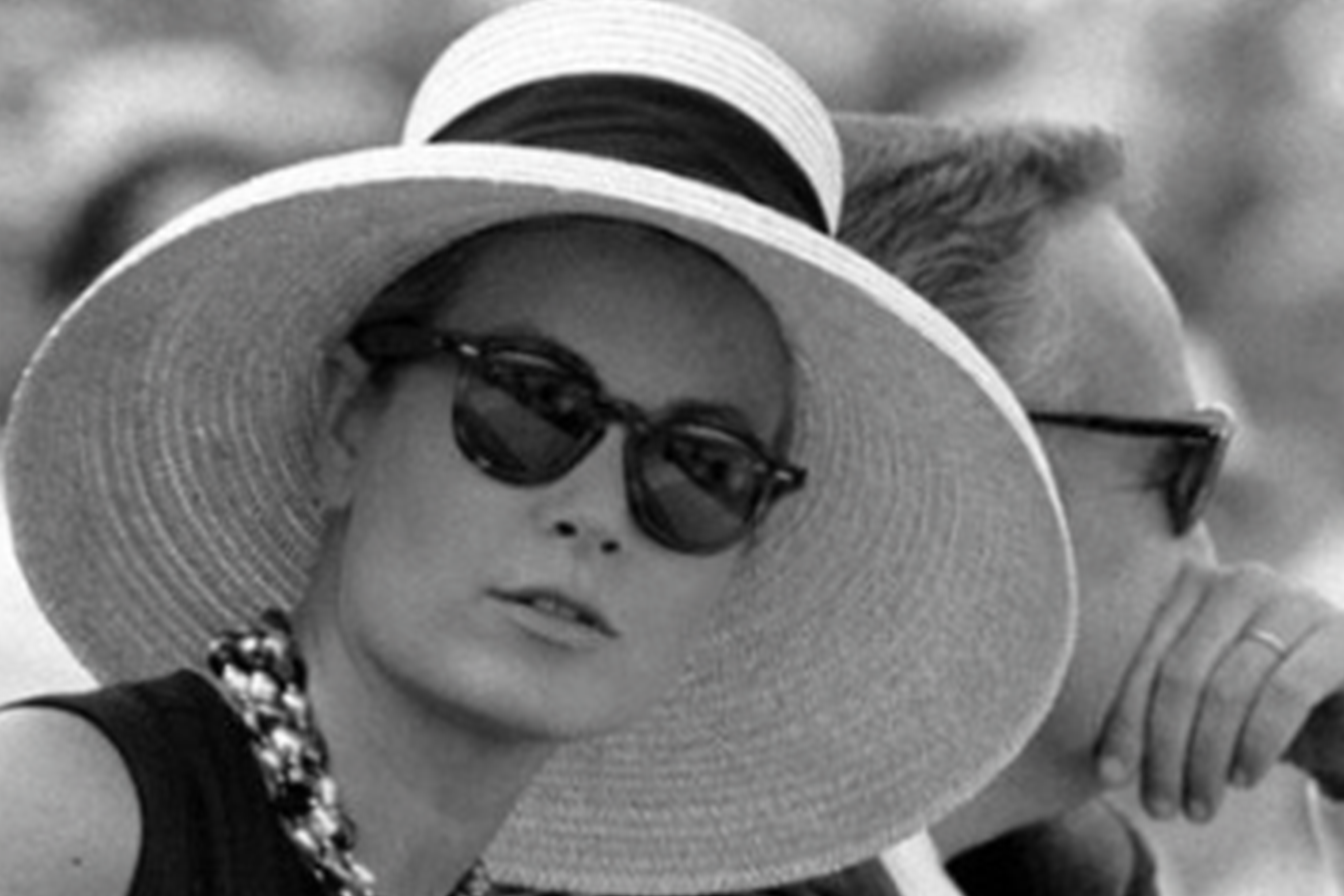 Grace Kelly wearing P3 style sunglasses and an oversized sun hat