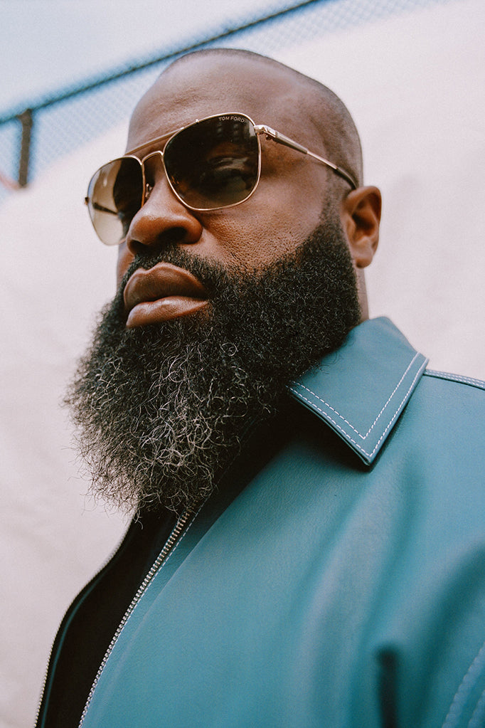 Black Thought wearing Tom Ford sunglasses and a blue leather jacket