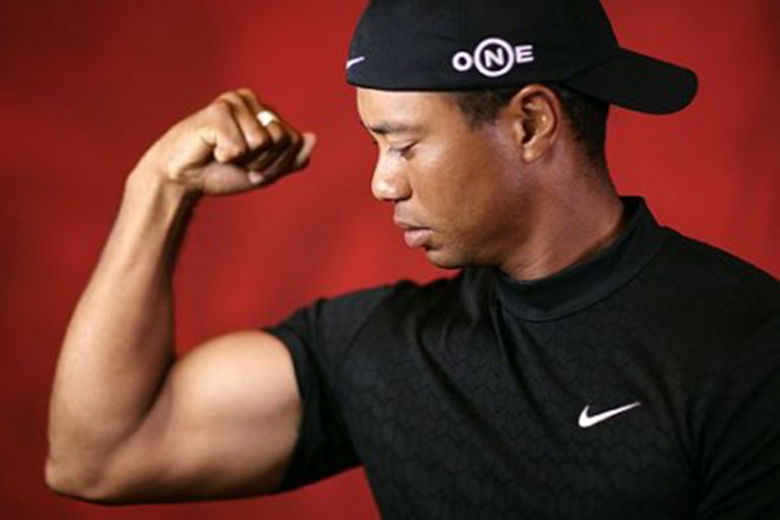 Tiger Woods flexing his arm