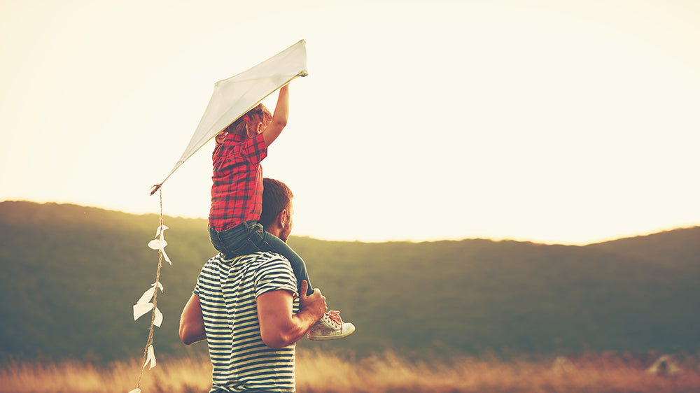 Flying a kite at a picnic