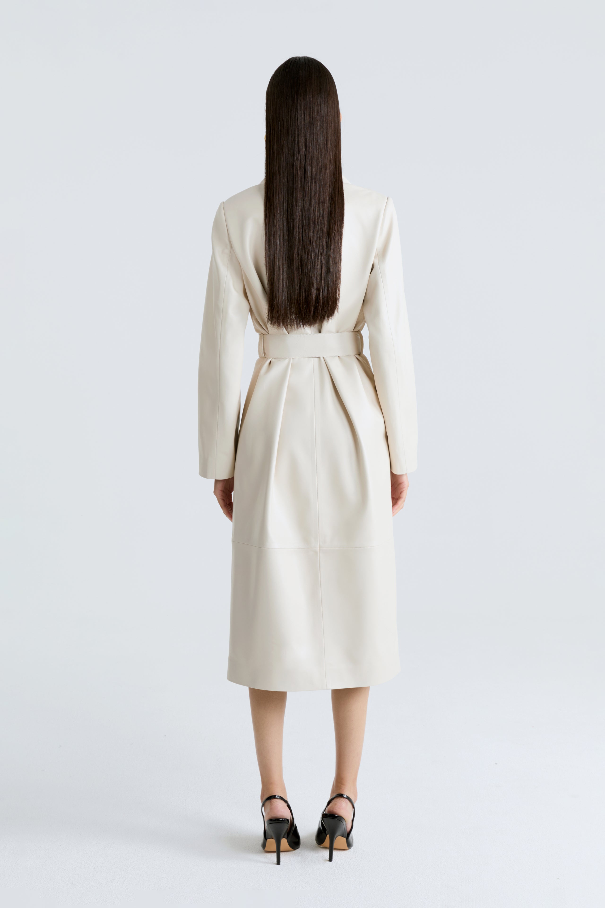 Model is wearing the Amina Ivory Belted Leather Coat Back