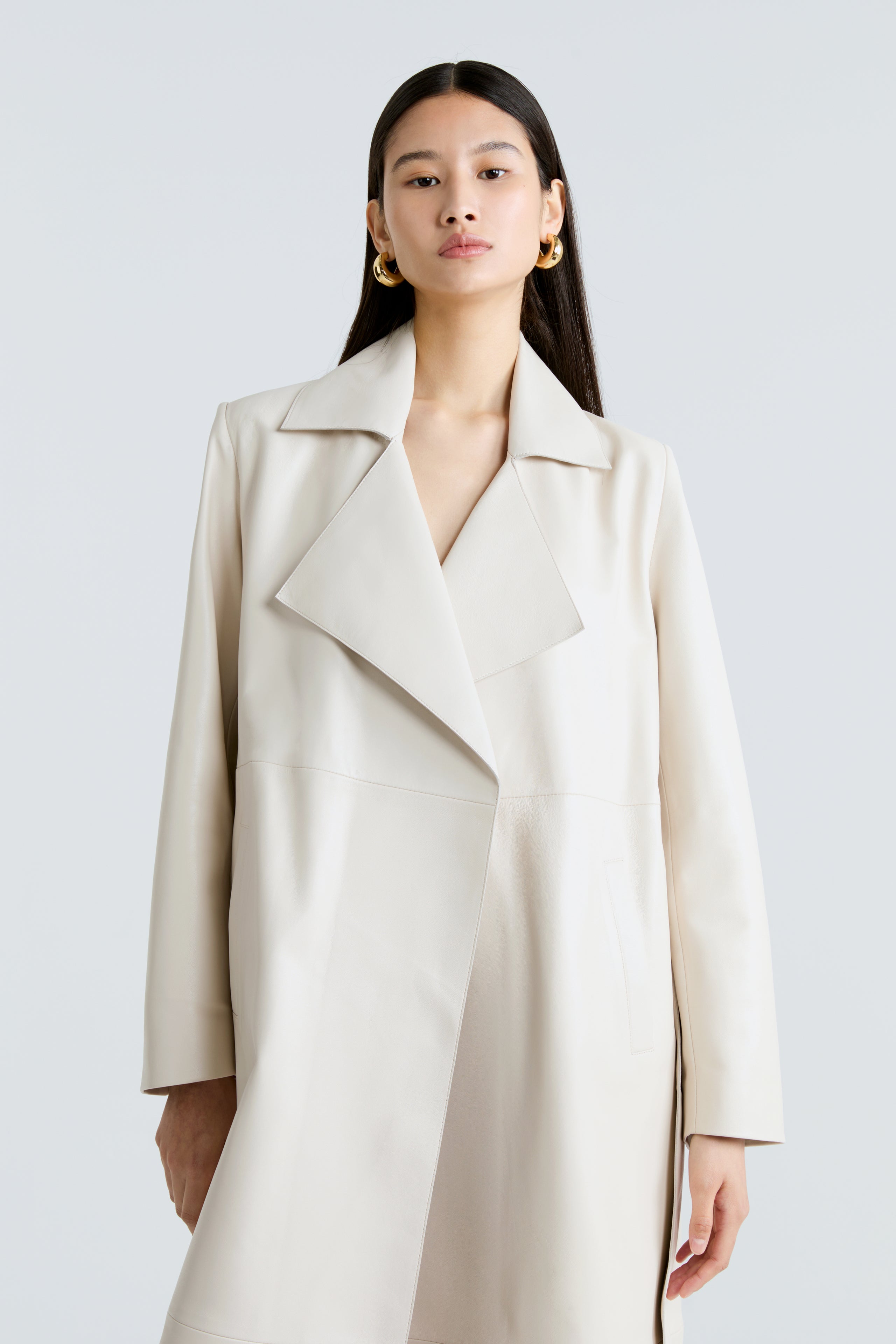 Model is wearing the Amina Ivory Belted Leather Coat Close Up