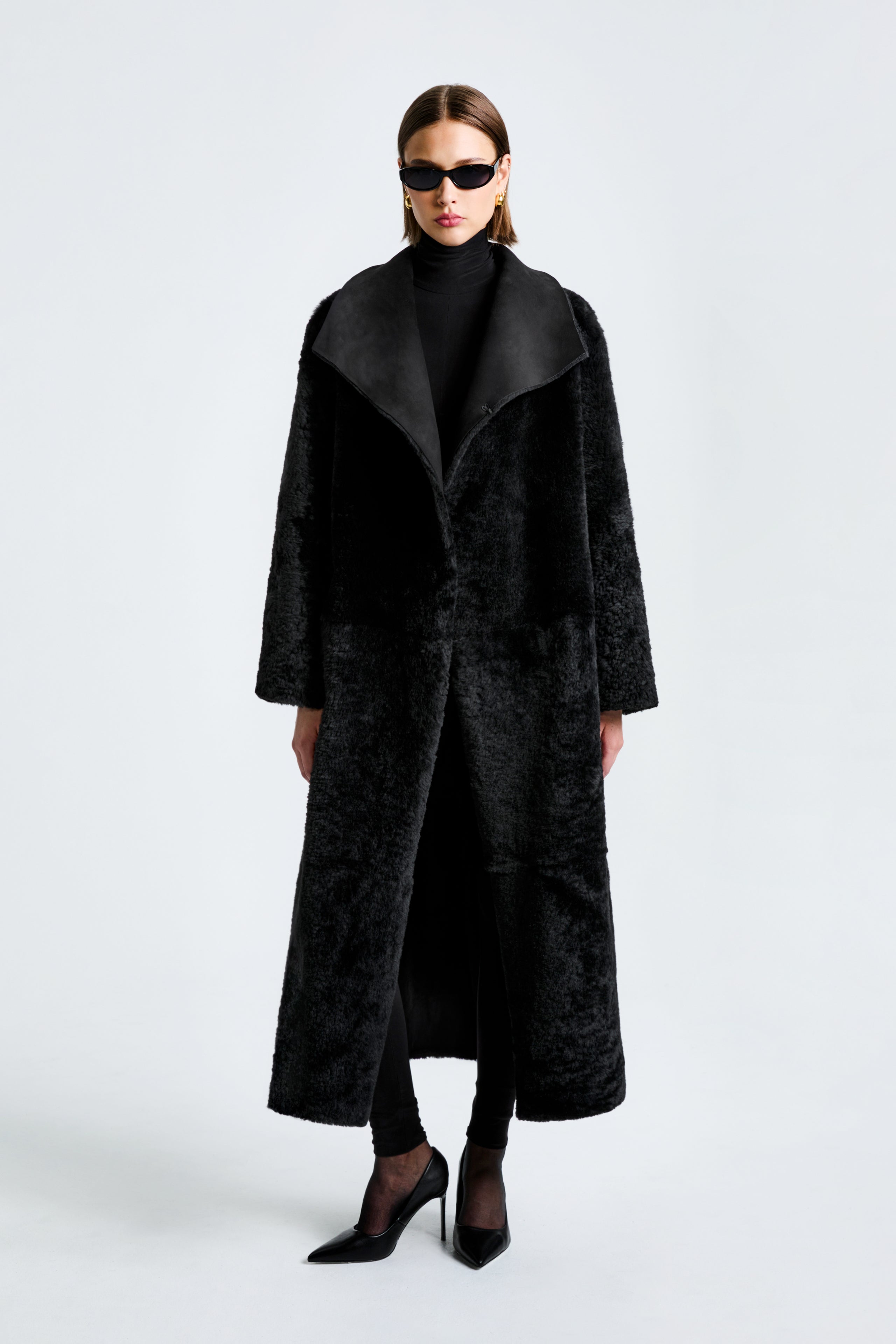 Model is wearing the Nour Hammour New Birthday Coat Black - Draped Shearling Coat - Front Open