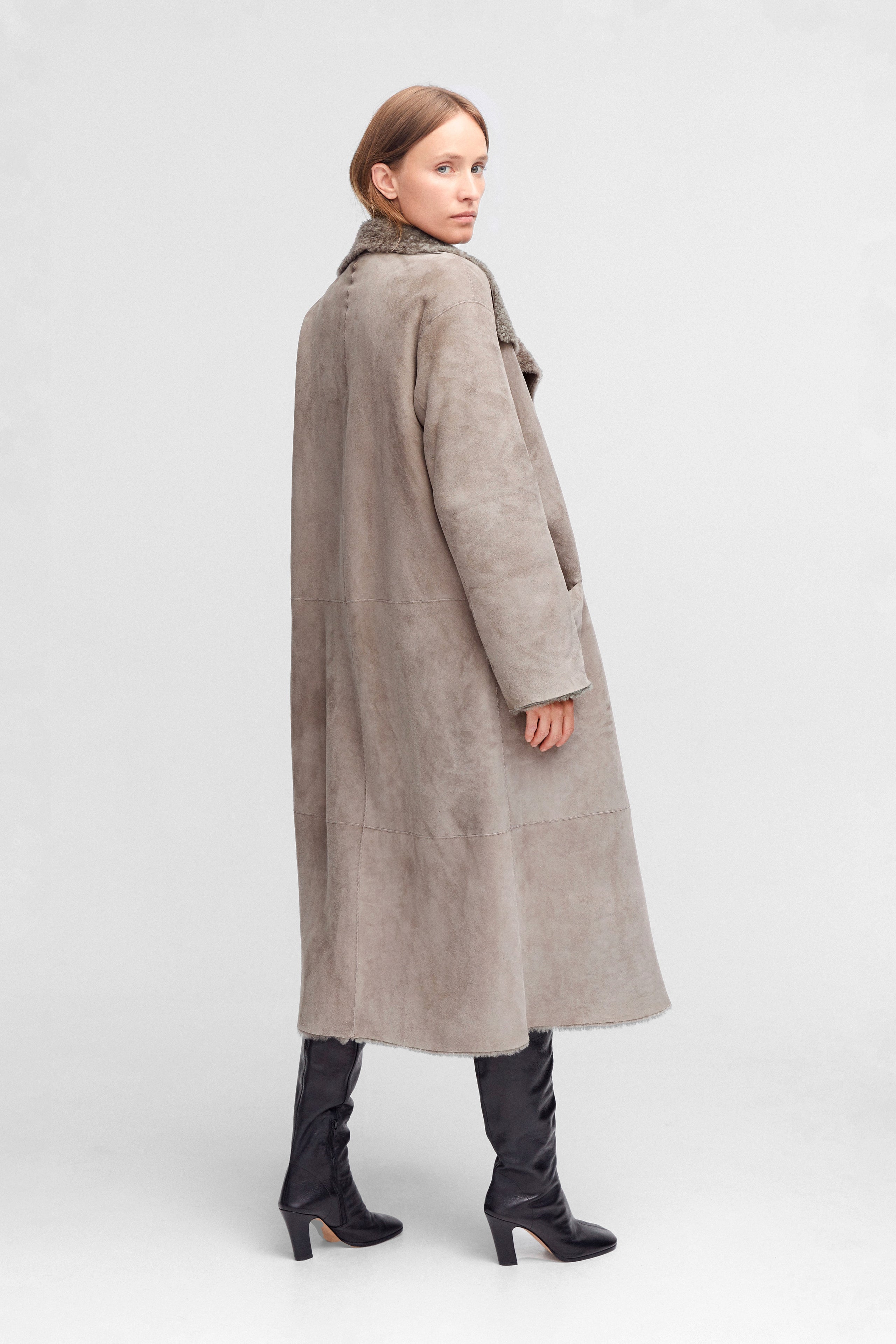 Model is wearing the Birthday Coat Iceland Grey Draped Shearling Coat Back