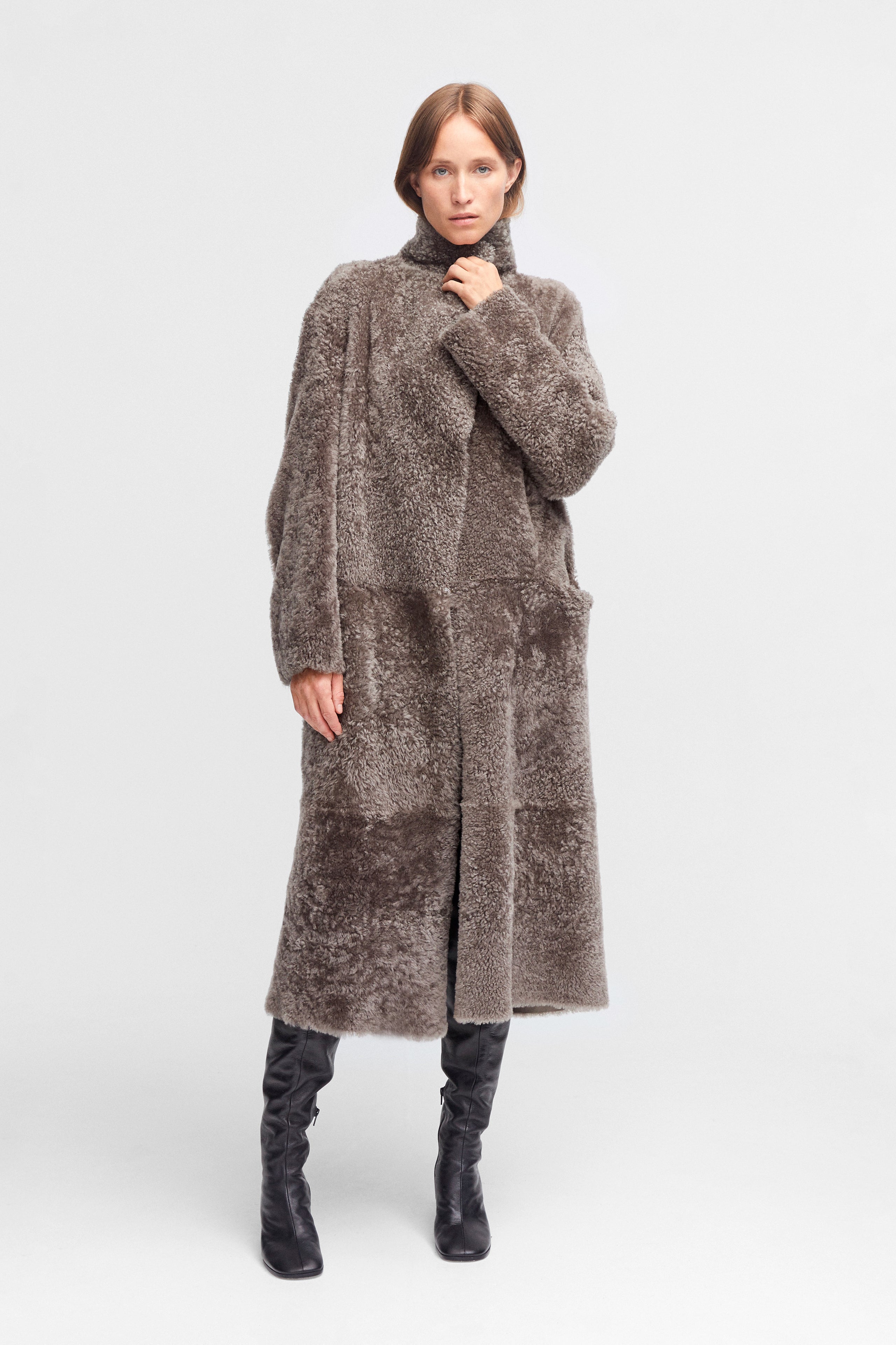 Model is wearing the Birthday Coat Iceland Grey Draped Shearling Coat Front