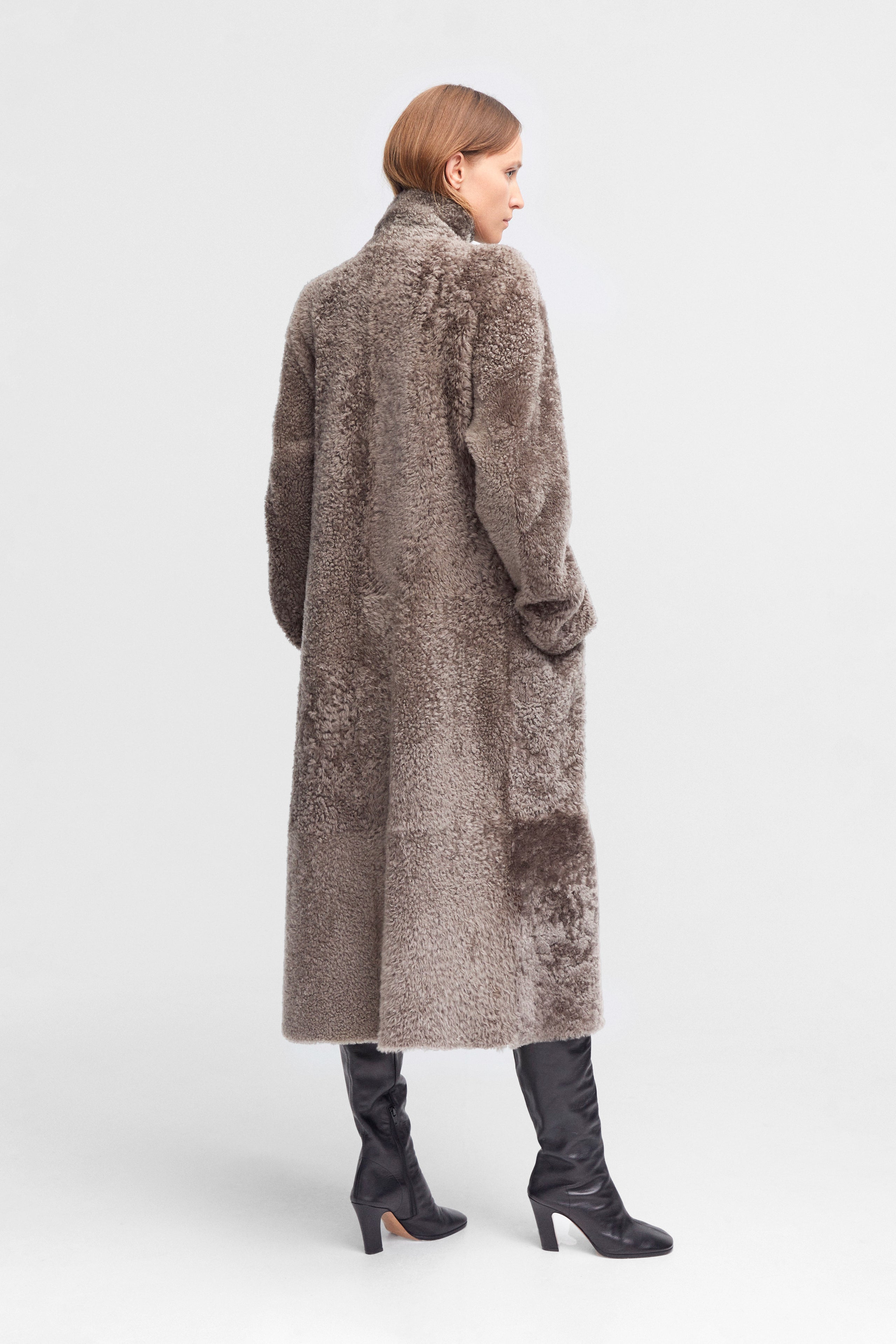 Model is wearing the Birthday Coat Iceland Grey Draped Shearling Coat Back