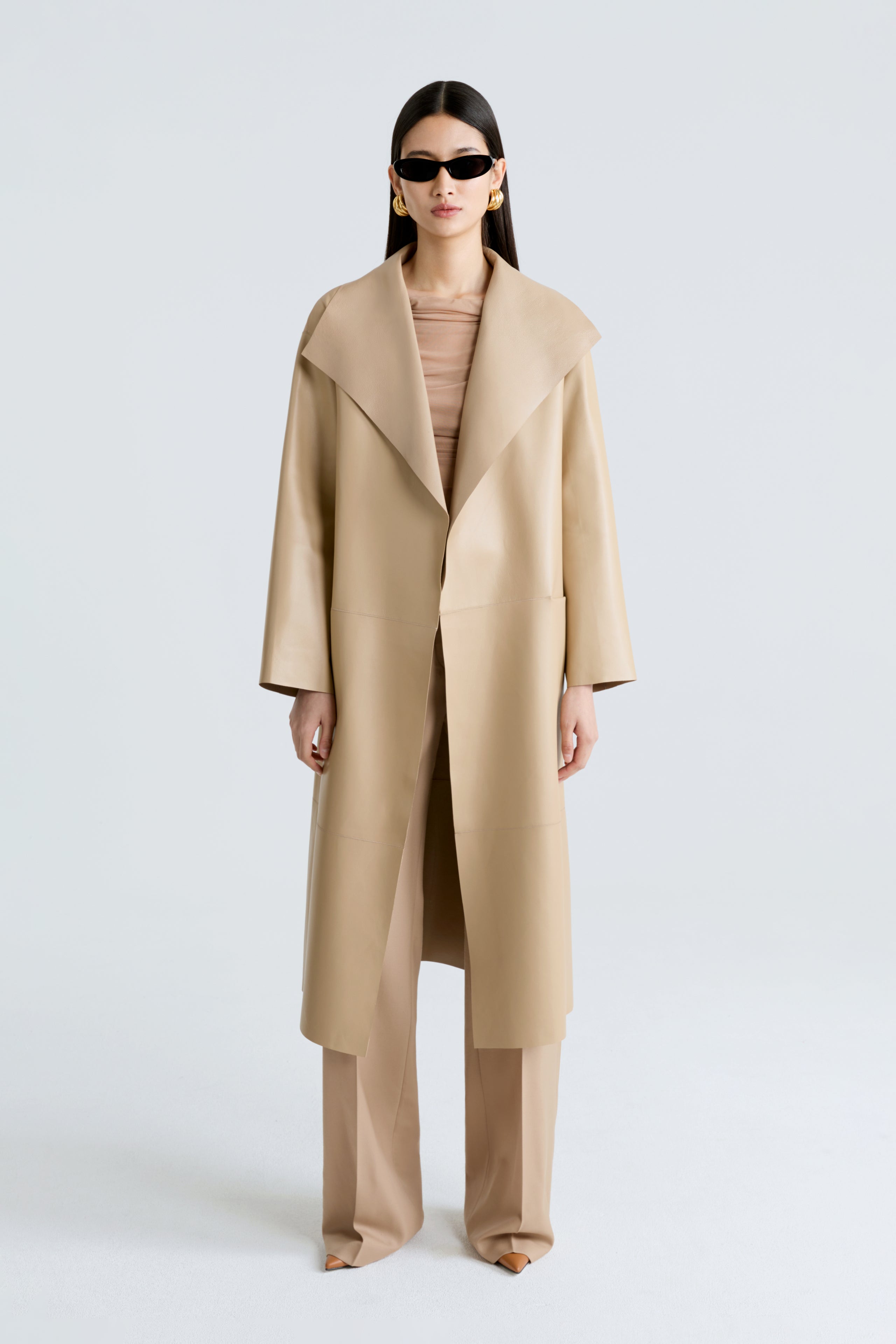 Model is wearing the Nour Hammour Birthday Coat Leather Beige Draped Leather Coat Front