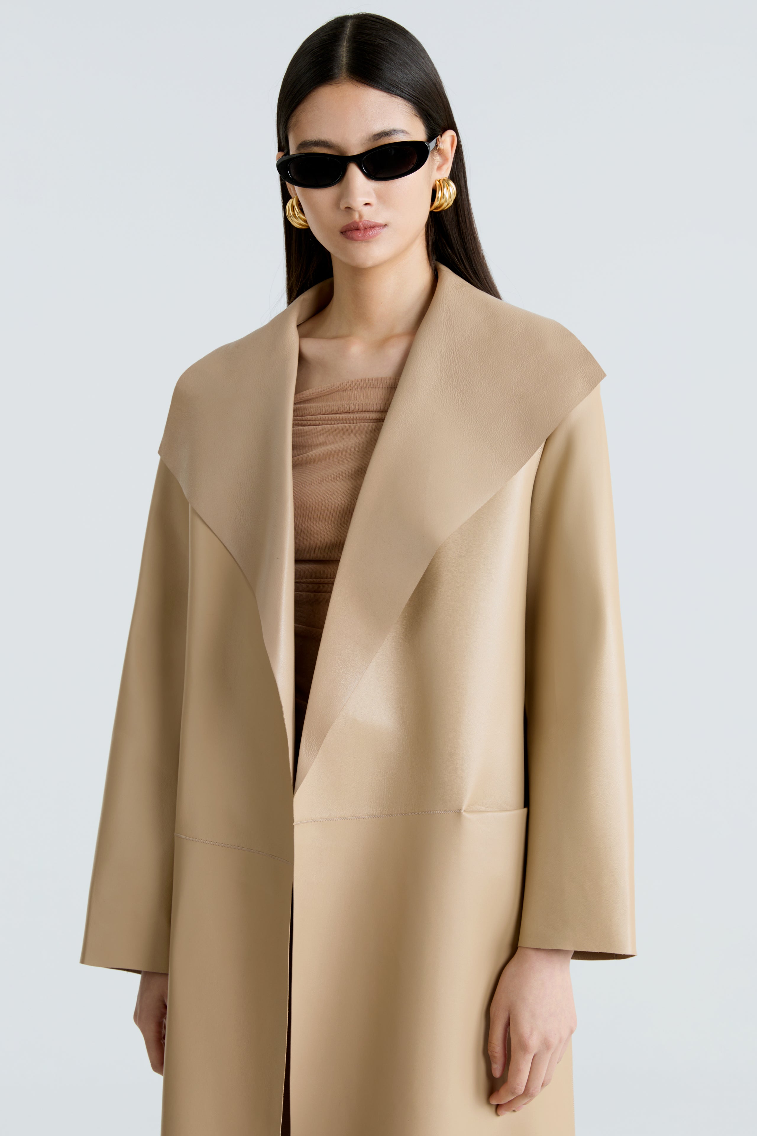 Model is wearing the Nour Hammour Birthday Coat Leather Beige Draped Leather Coat Close Up