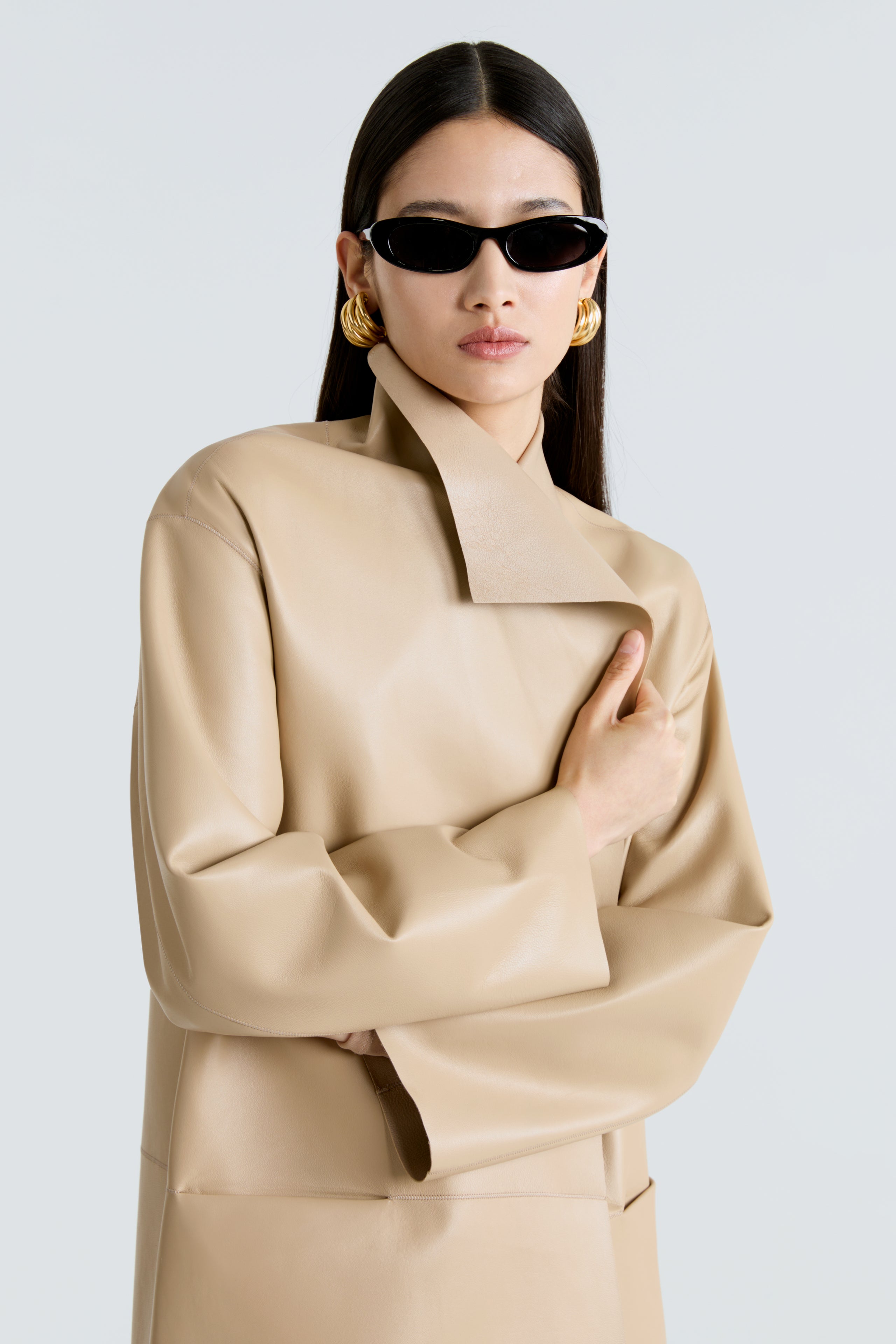 Model is wearing the Nour Hammour Birthday Coat Leather Beige Draped Leather Coat Close Up