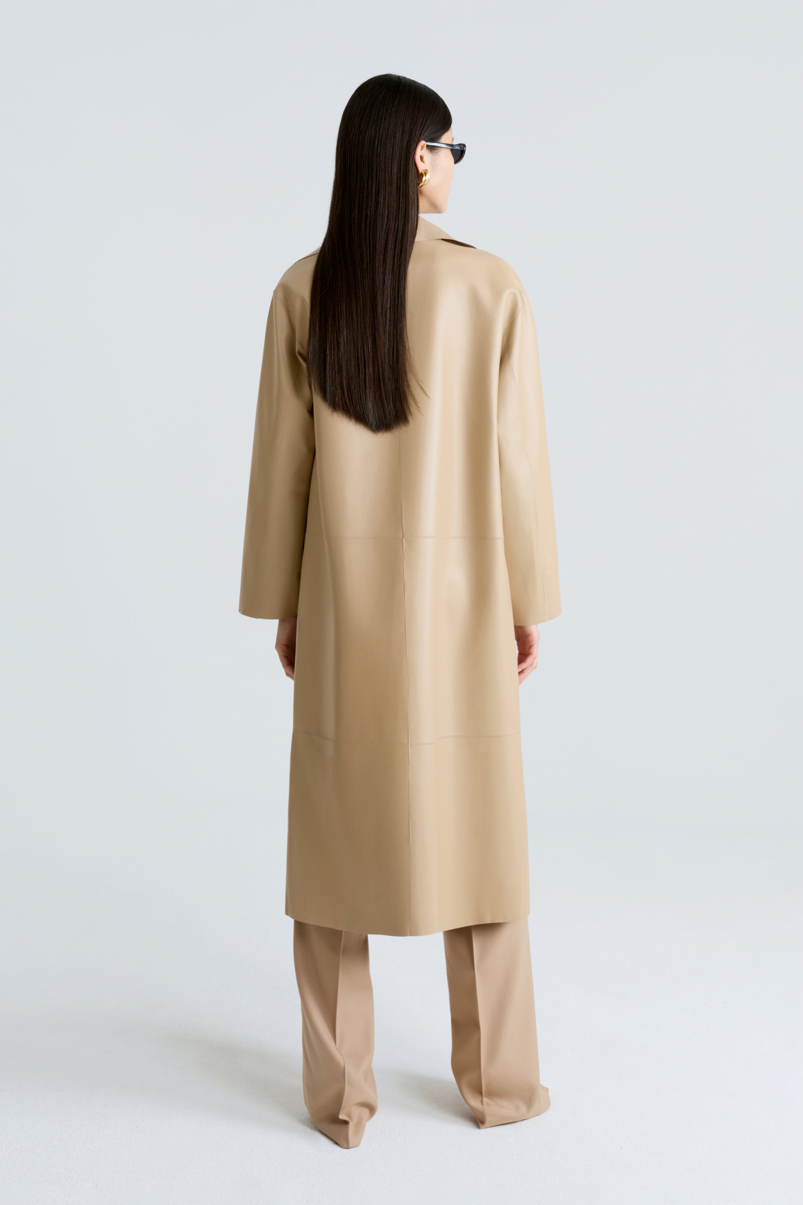 Model is wearing the Nour Hammour Birthday Coat Leather Beige Draped Leather Coat Back