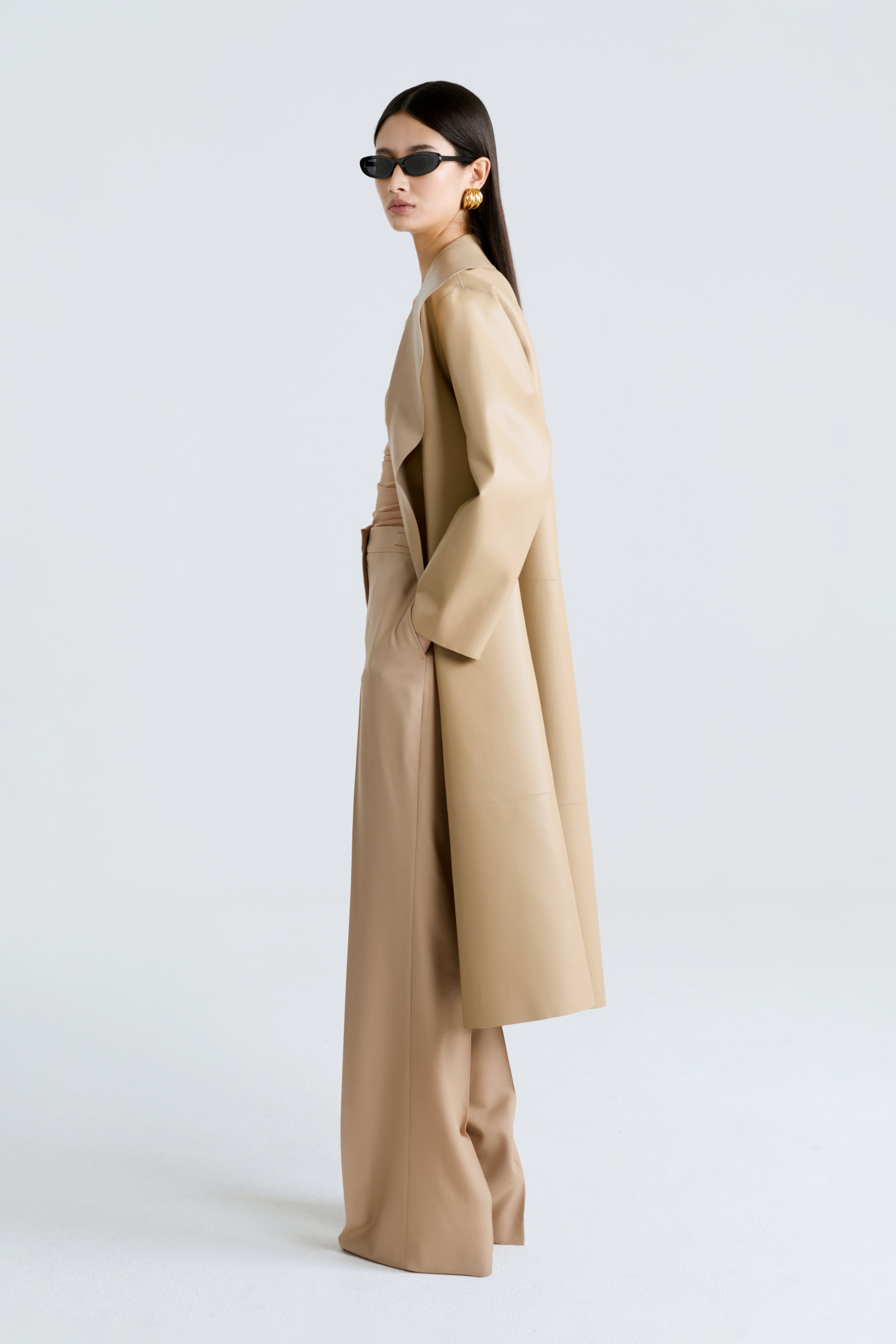 Model is wearing the Nour Hammour Birthday Coat Leather Beige Draped Leather Coat Side