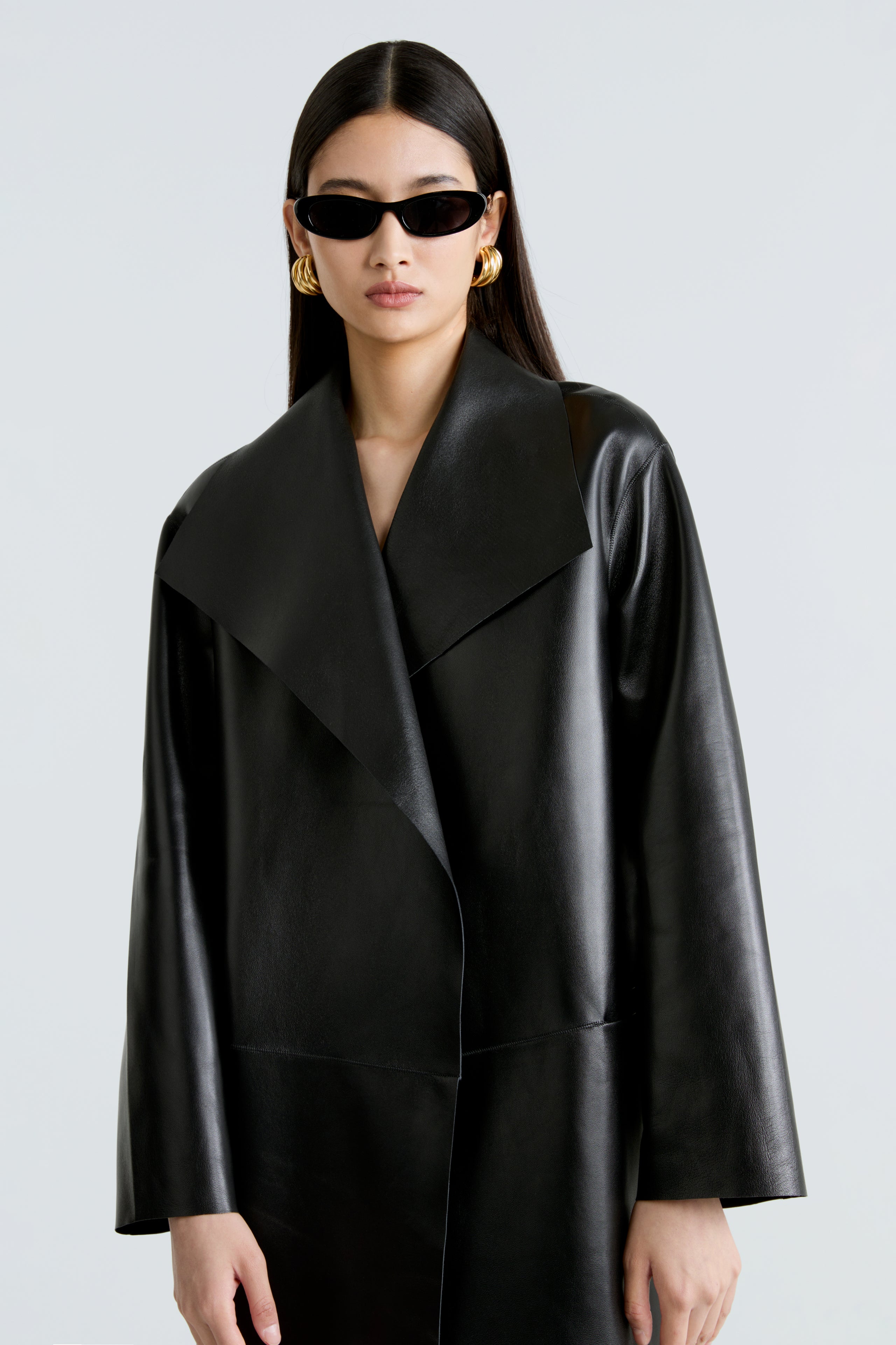 Model is wearing the Nour Hammour Birthday Coat Leather Black Draped Leather Coat Close Up