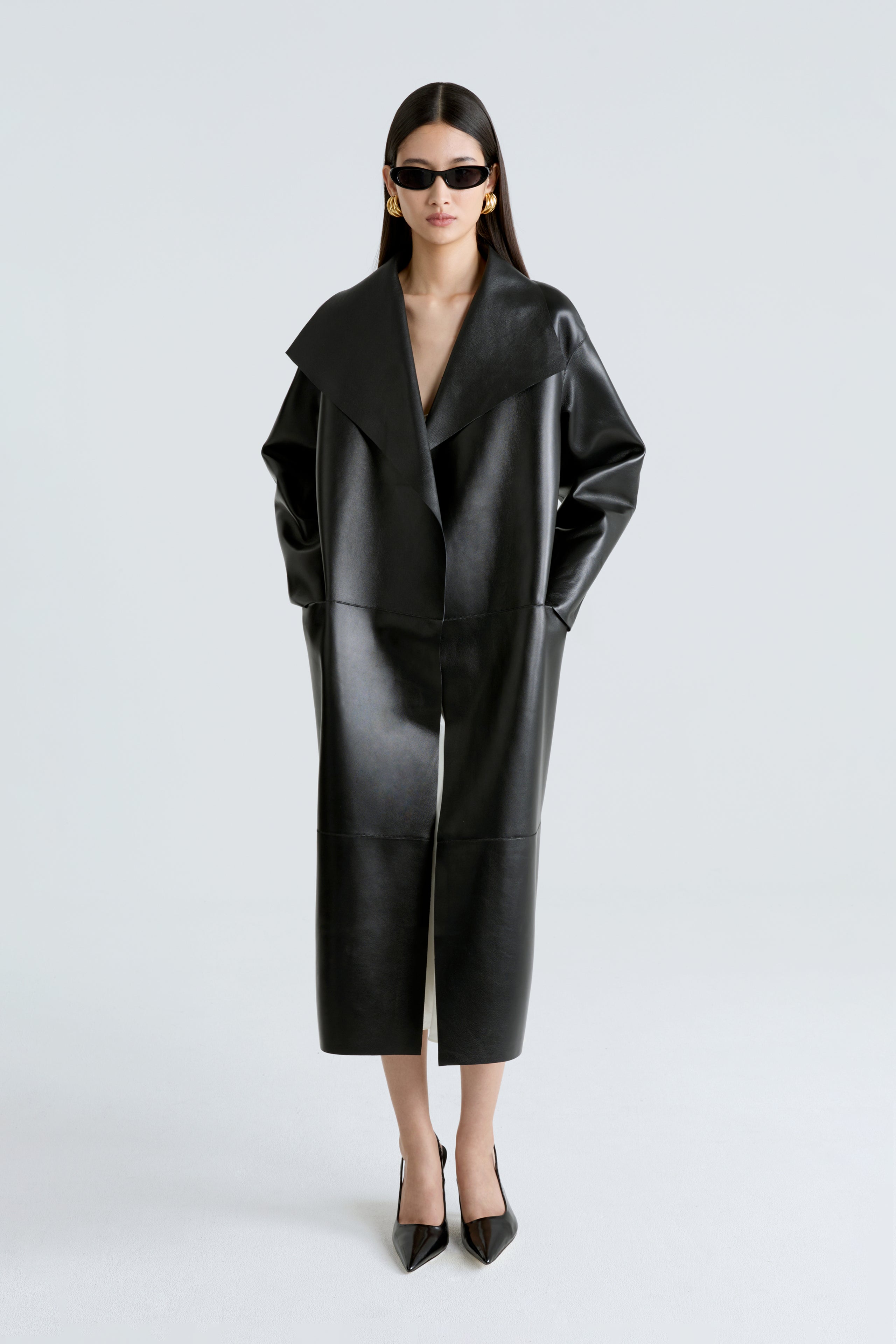 Model is wearing the Nour Hammour Birthday Coat Leather Black Draped Leather Coat Front