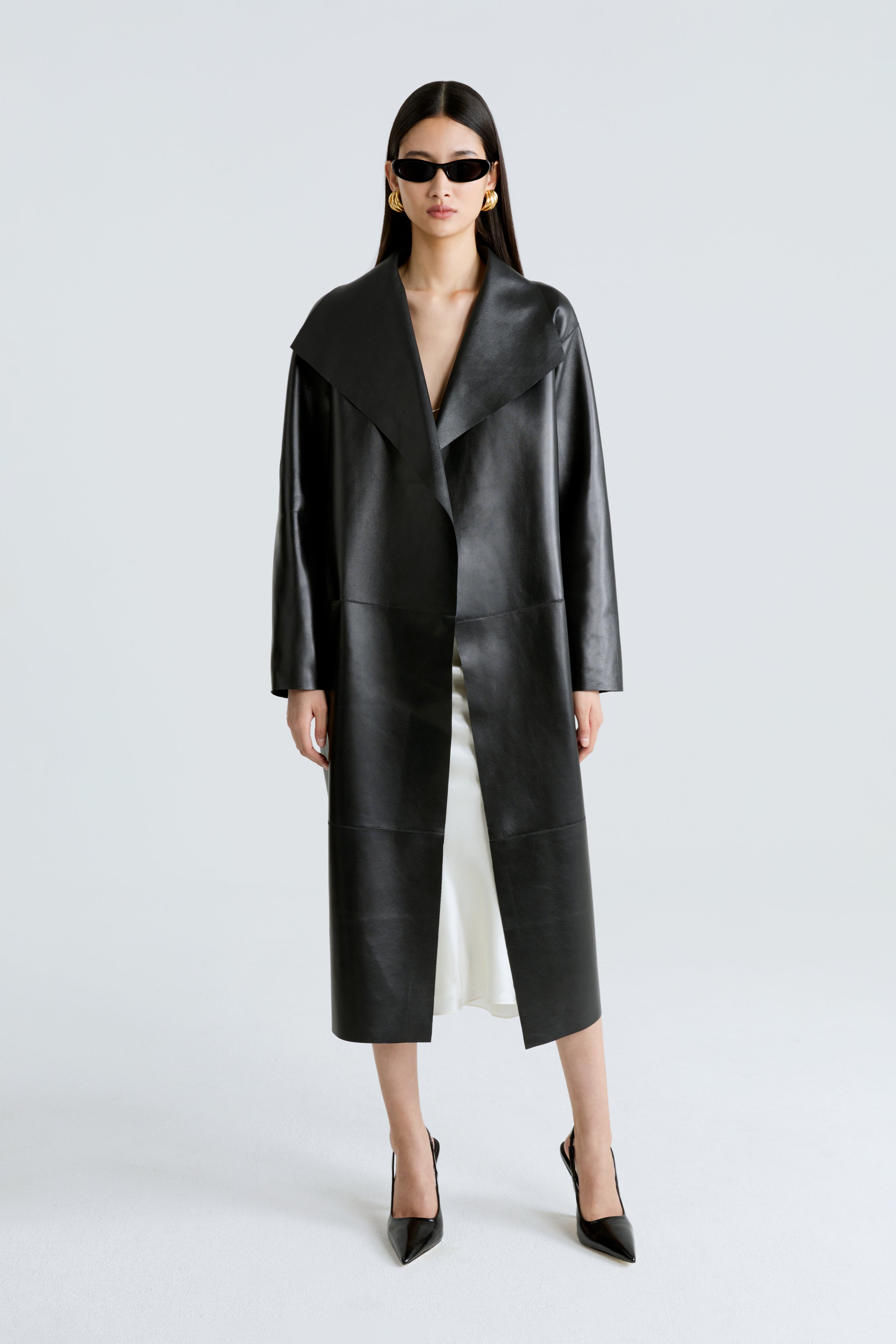 Model is wearing the Nour Hammour Birthday Coat Leather Black Draped Leather Coat Front