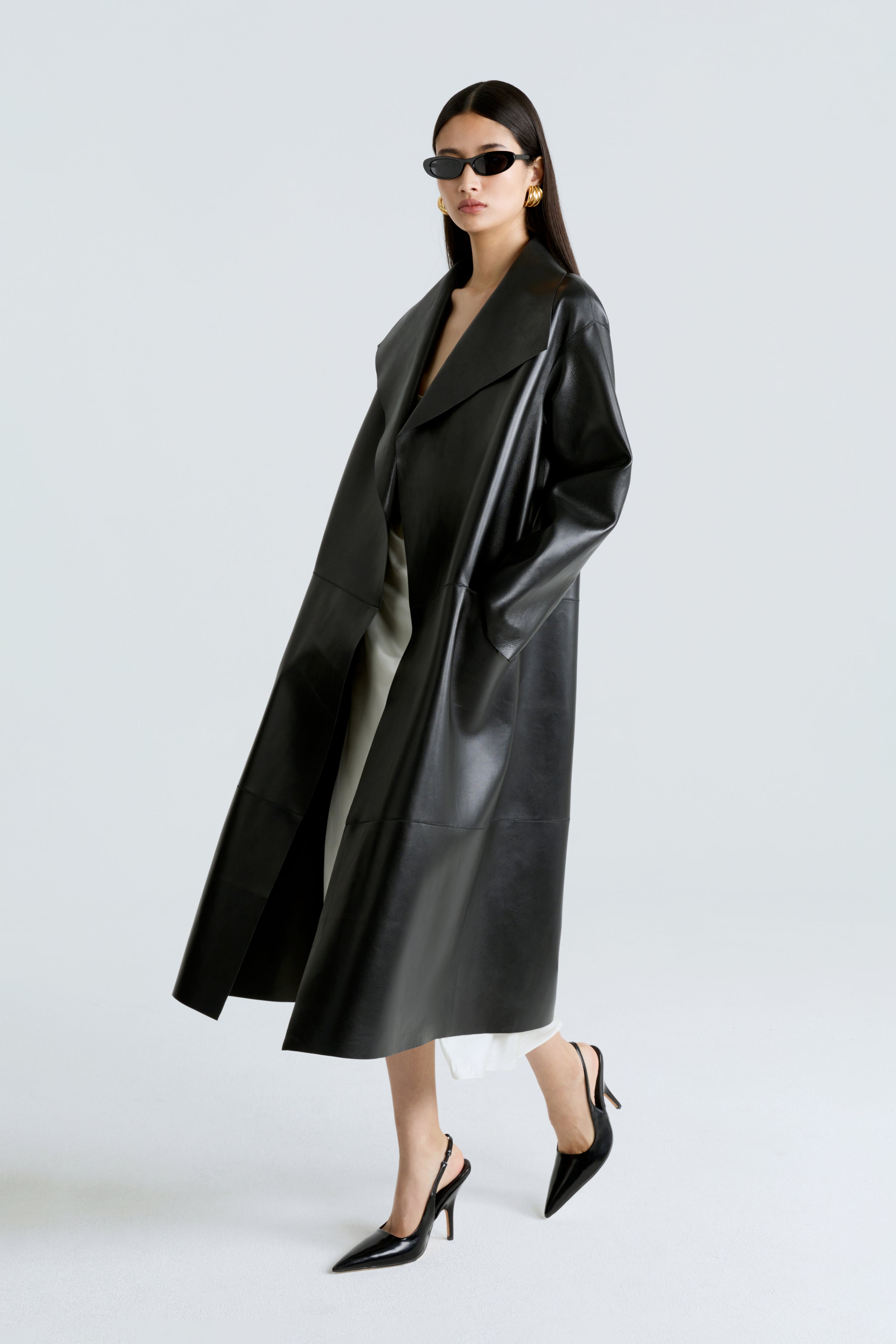 Model is wearing the Nour Hammour Birthday Coat Leather Black Draped Leather Coat Side